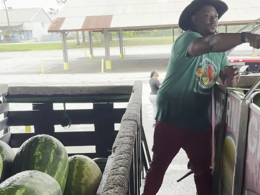 Kenny Smith loading watermelons into his truck at a Southern farm